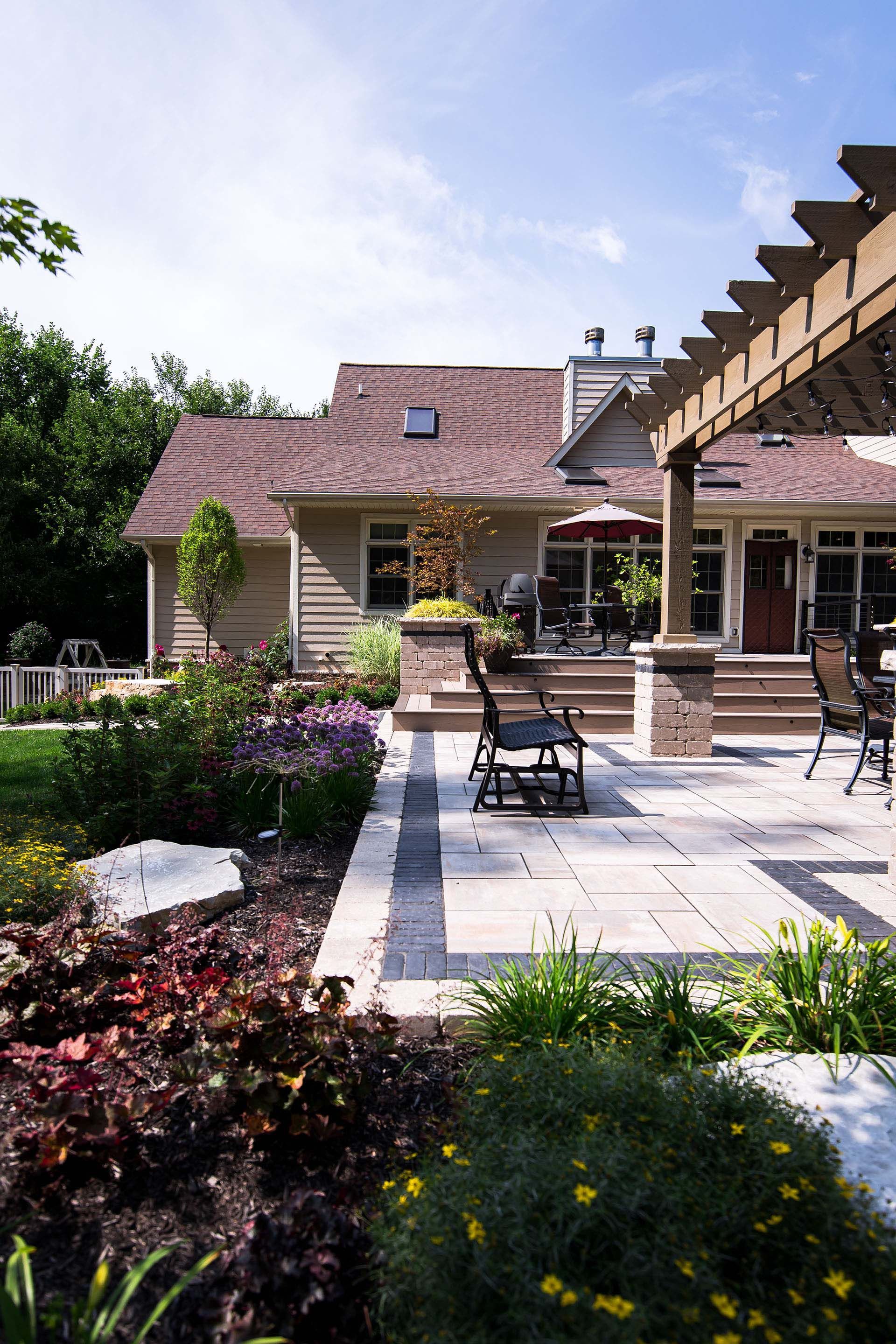 A house with a patio and a pergola in front of it