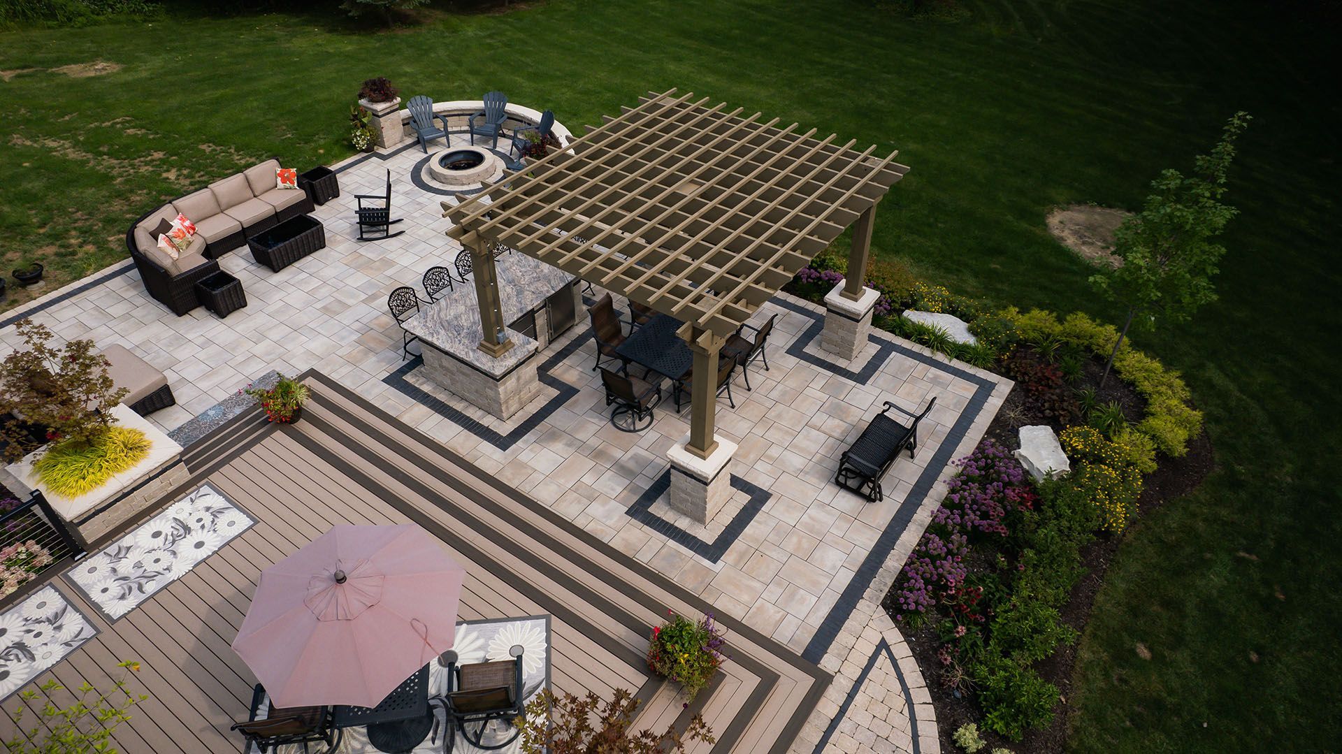 An aerial view of a patio with a pergola and a fire pit.