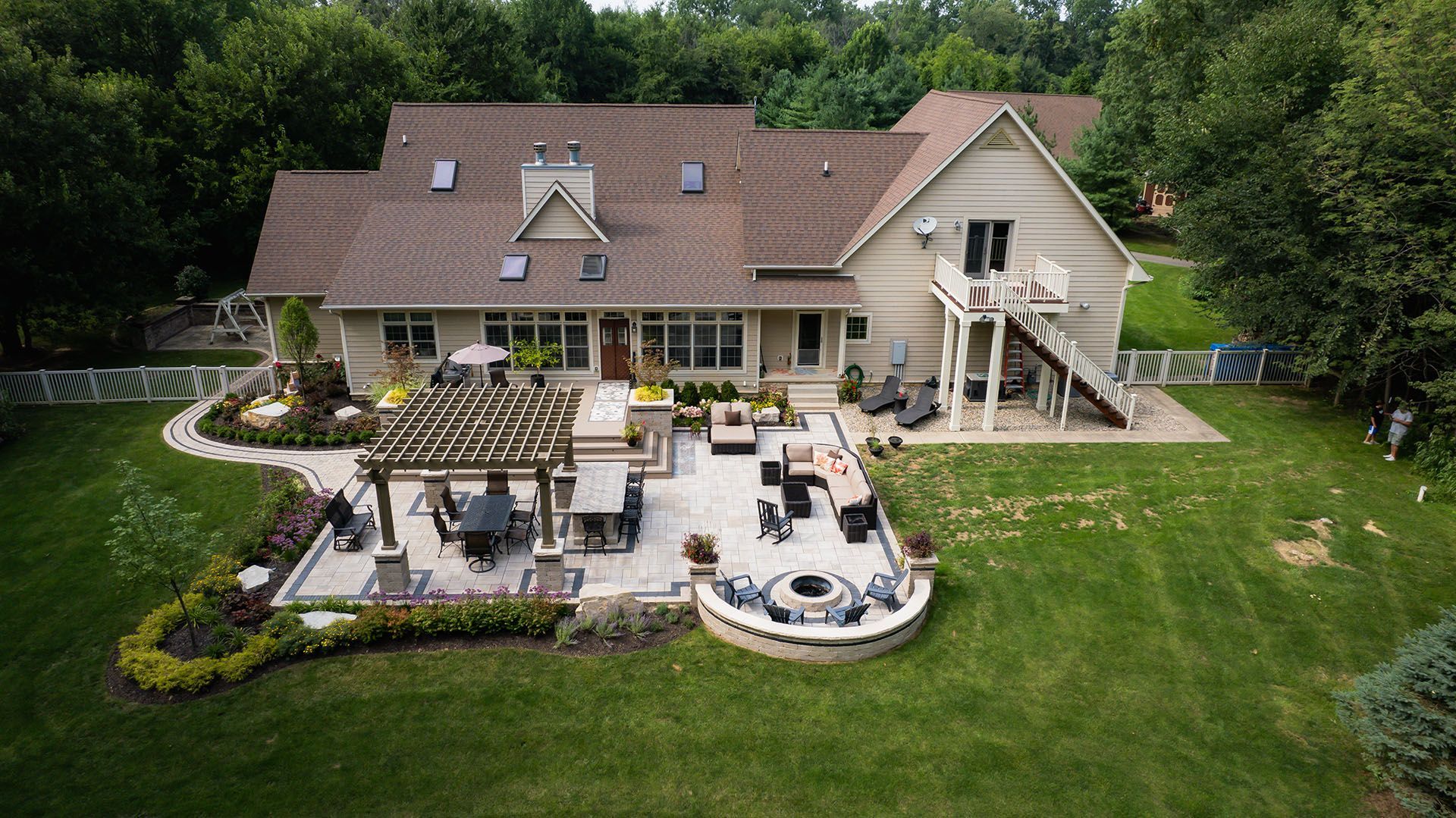 An aerial view of a large house with a patio in front of it.