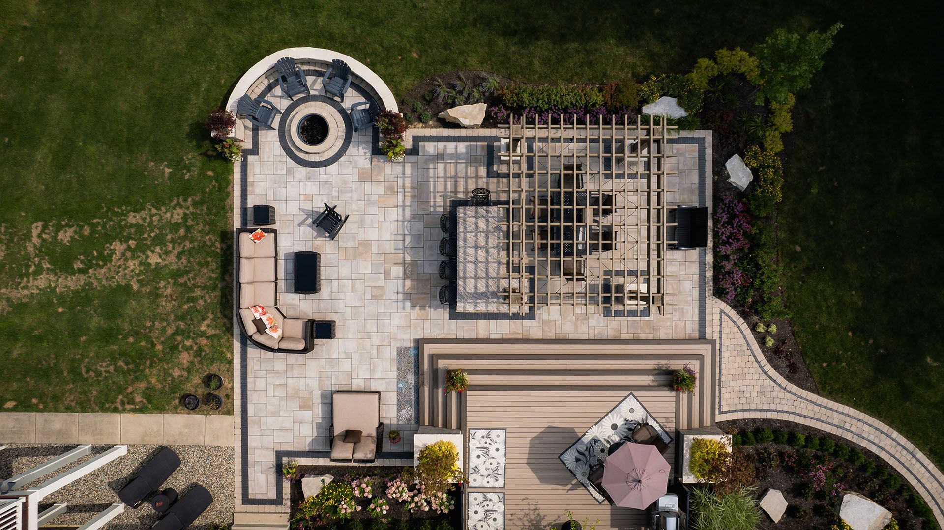 An aerial view of a patio with furniture and a fire pit.