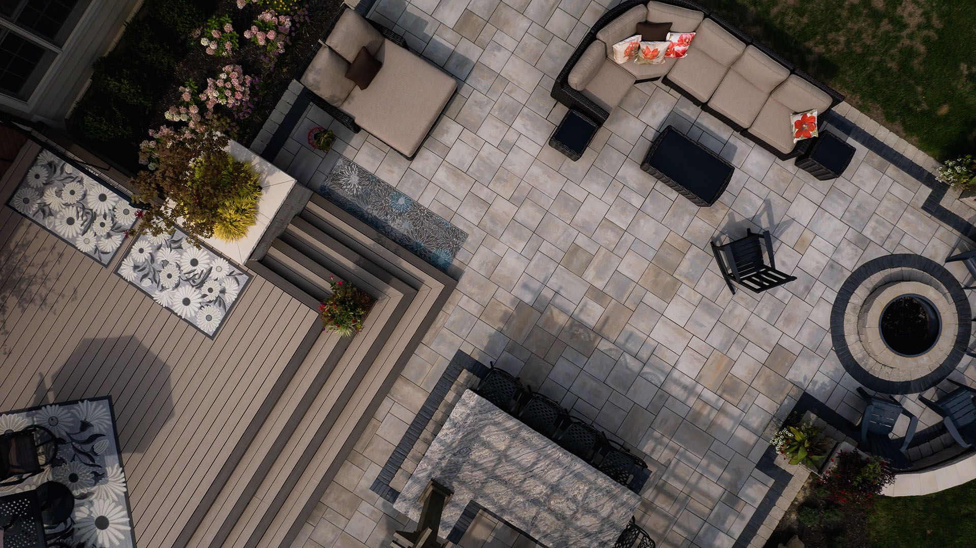 An aerial view of a patio with furniture and a fire pit.