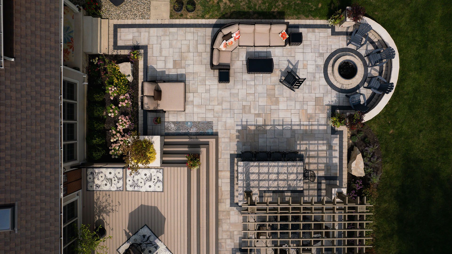 An aerial view of a patio with furniture and a fire pit.