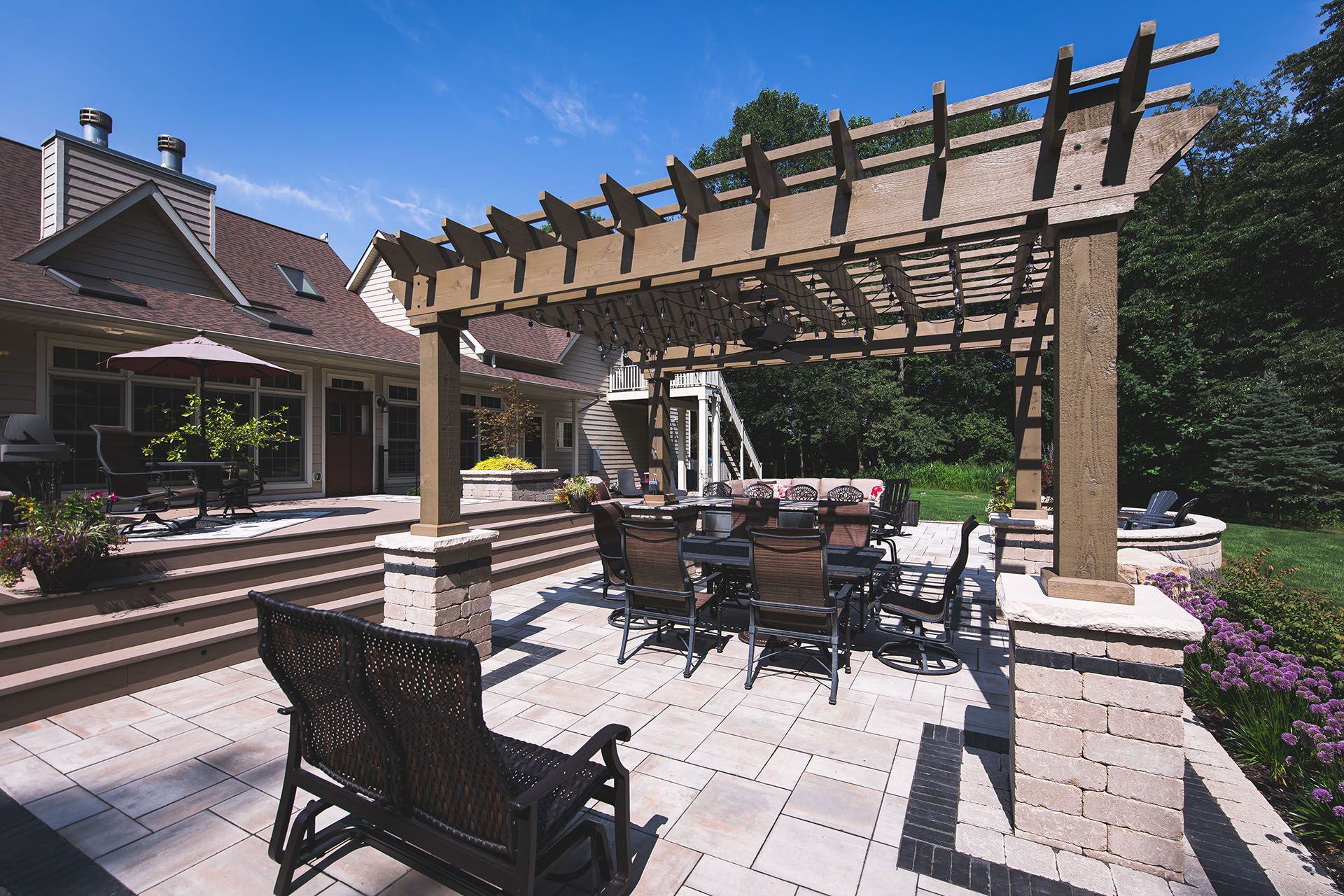 A patio with a table and chairs under a pergola