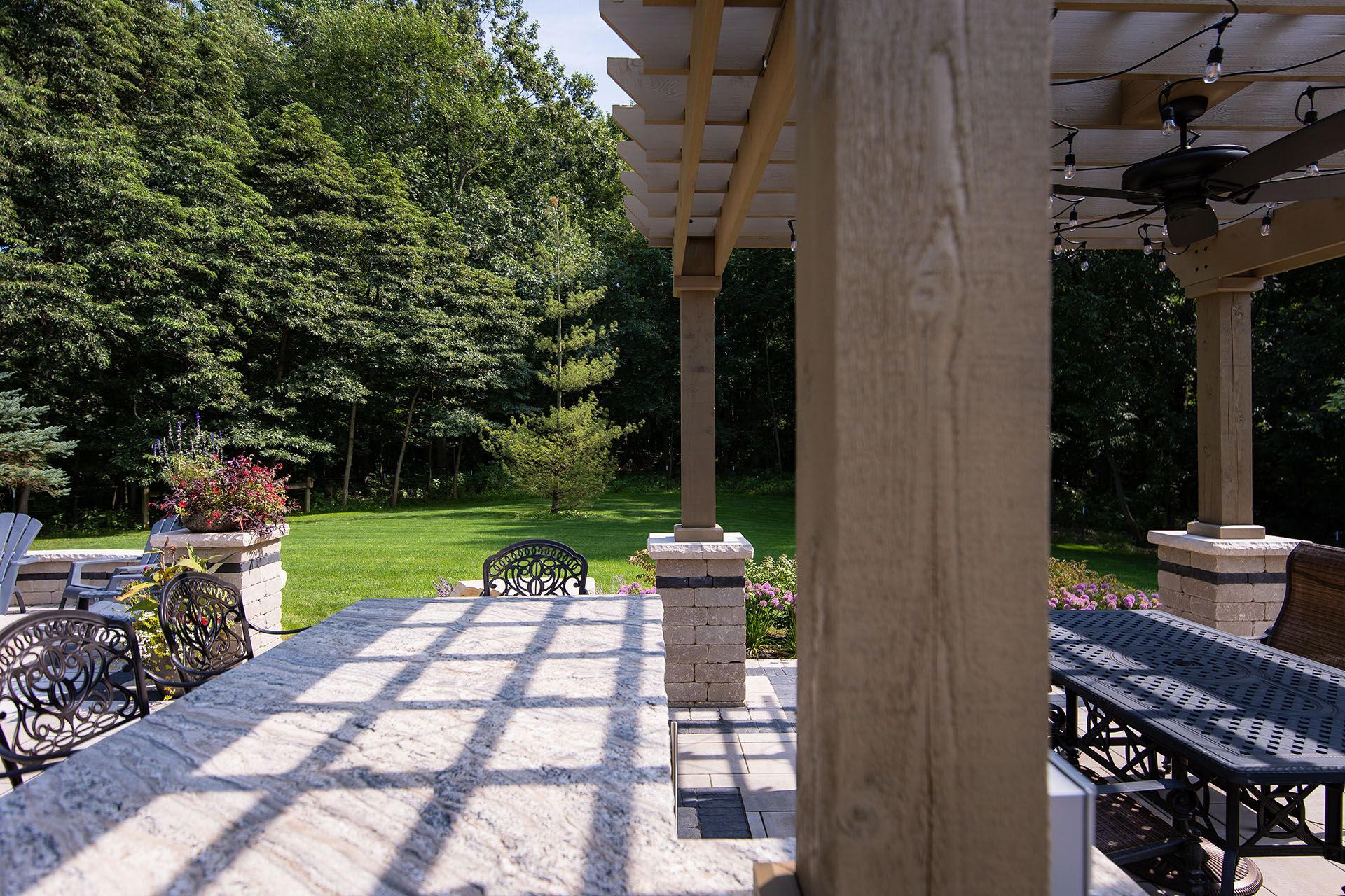 A patio with a table and chairs under a pergola