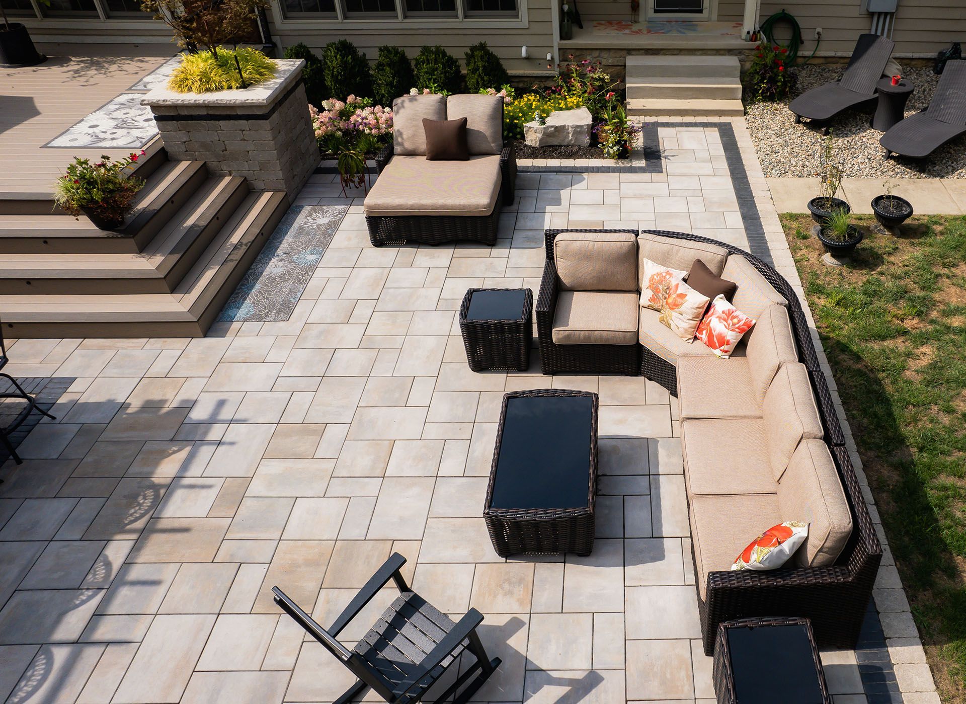 An aerial view of a patio with a sectional couch and chairs.