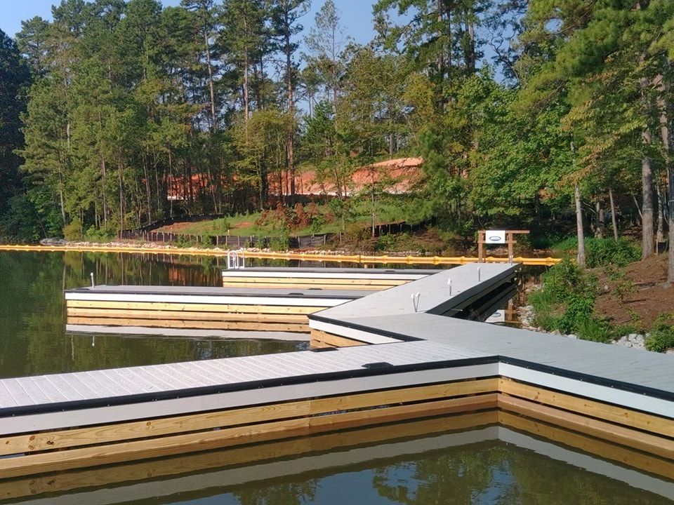 Docks on a lake, surrounded by trees.