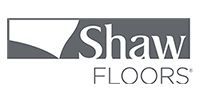 Shaw Floors logo in gray and black with stylized roof icon