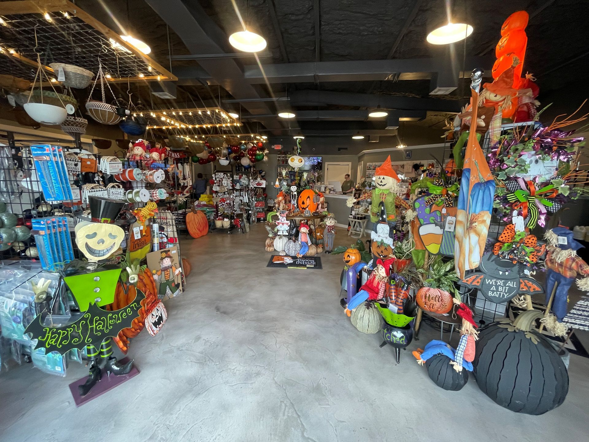 Inside a retail store, Halloween decorations line shelves and displays.