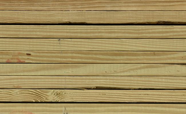 A close up of a stack of wooden boards.