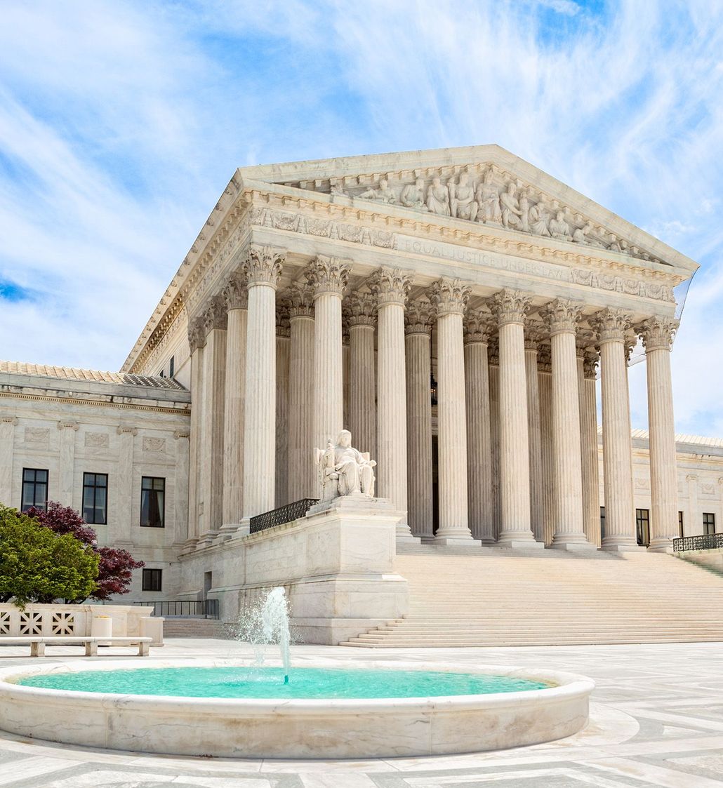 U.S. Supreme Court building with grand columns and a fountain in the foreground