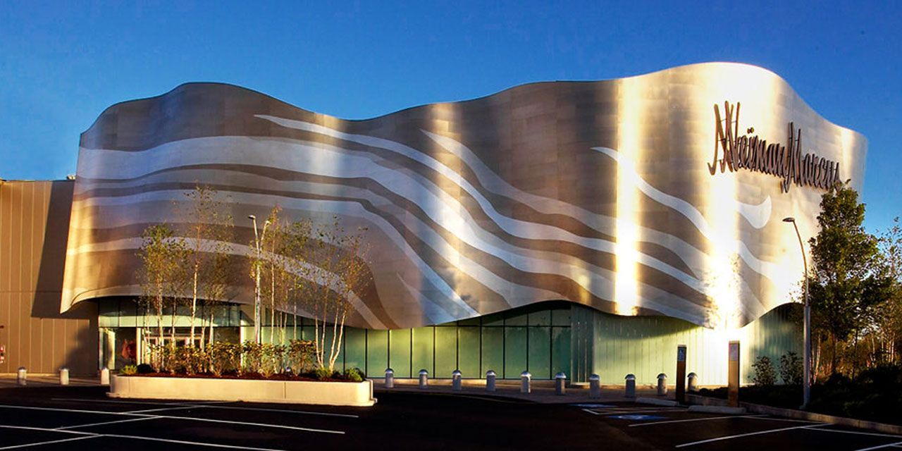 The facade of a Margaritaville store building in daylight. Metallic silver with wavy designs and logo.