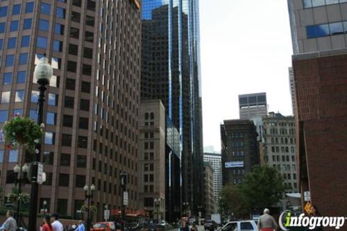 Downtown Boston street with tall buildings and pedestrians.