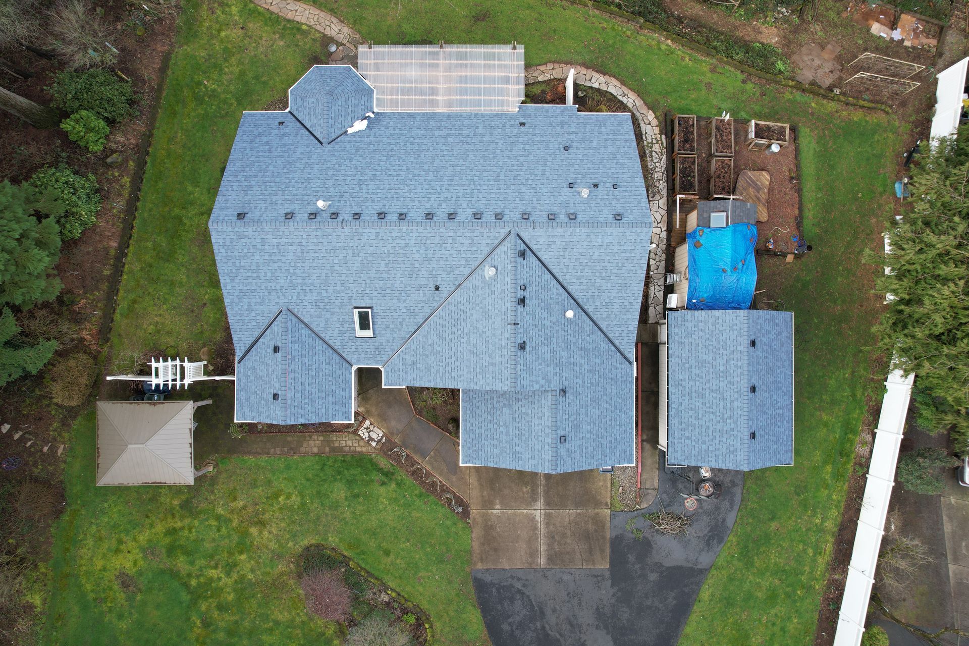 an aerial view of a large house with a blue roof