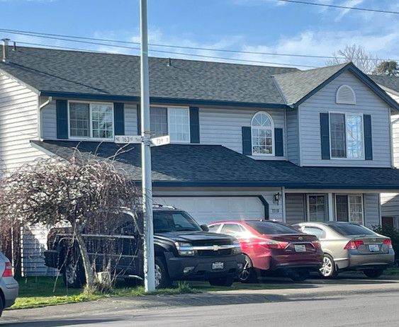 a house with a lot of cars parked in front of it