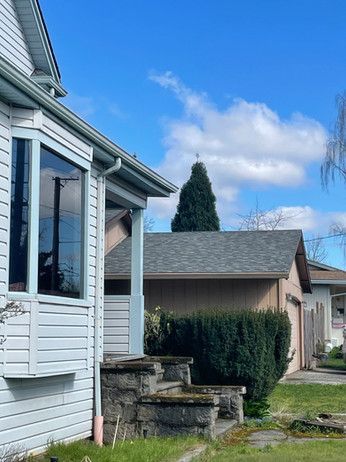 a white house with a porch and stairs in front of it