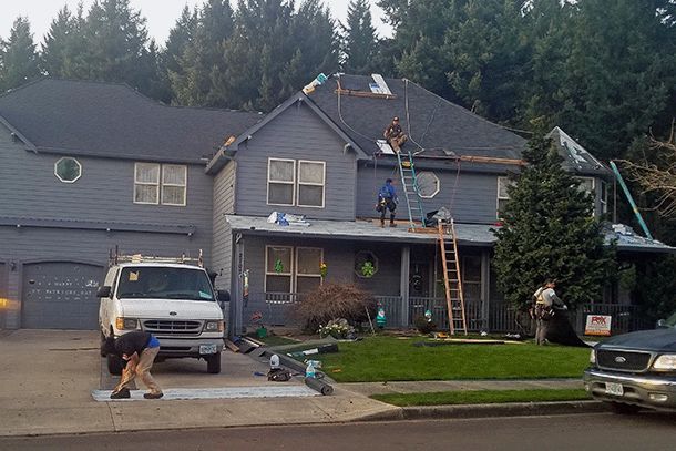 a white van is parked in front of a house that is being remodeled