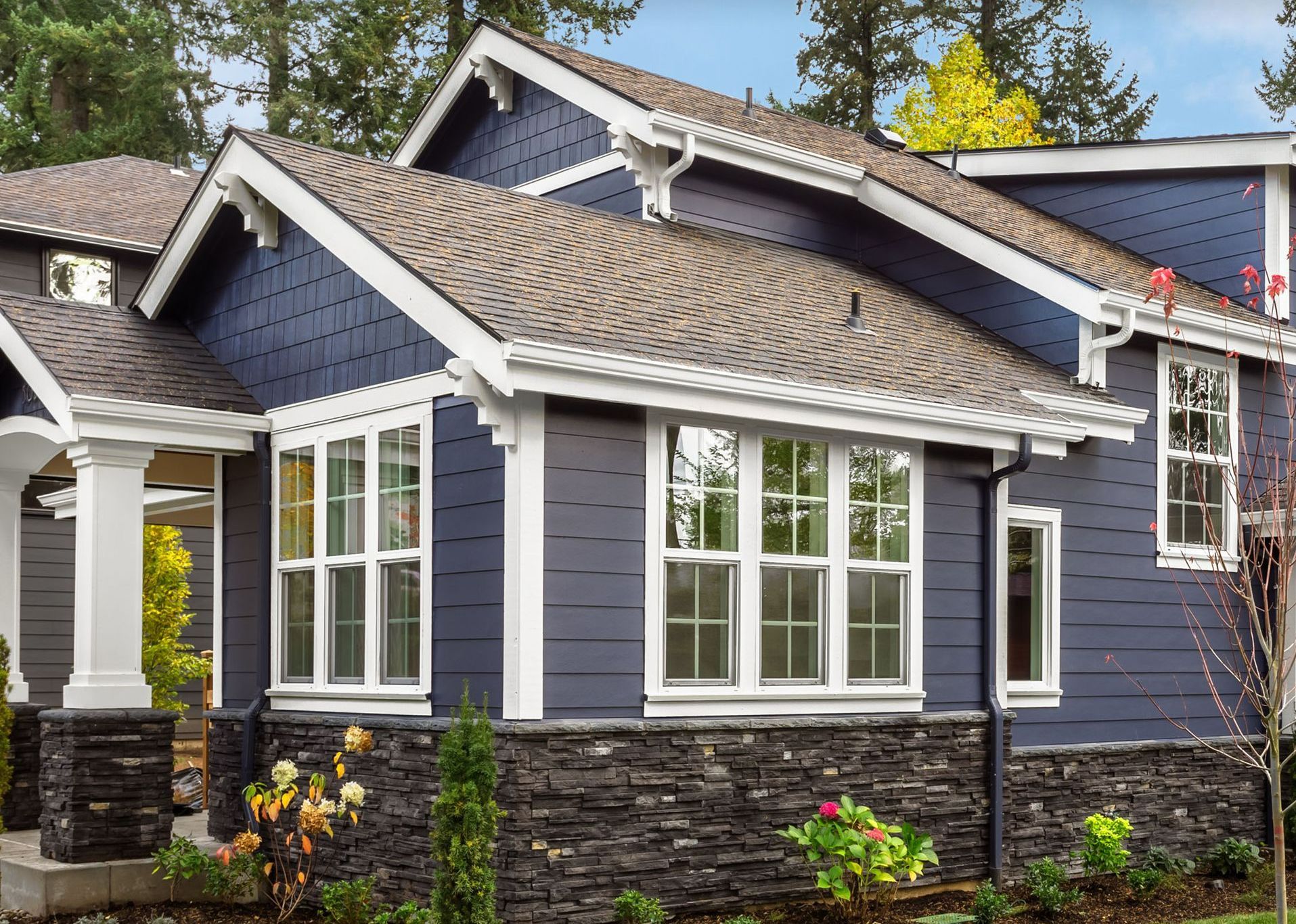 a blue house with white trim and purple siding