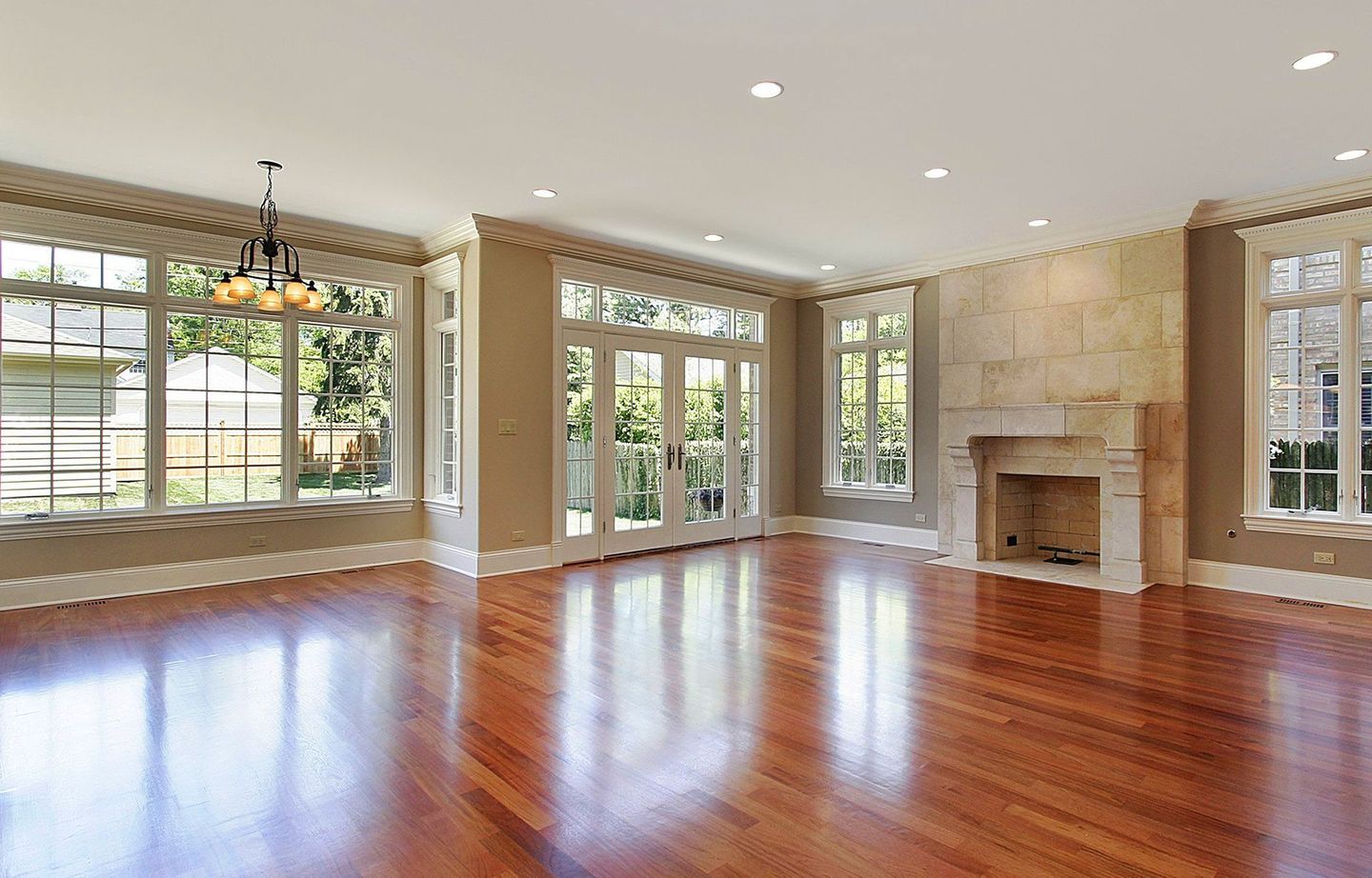 an empty living room with hardwood floors and a fireplace
