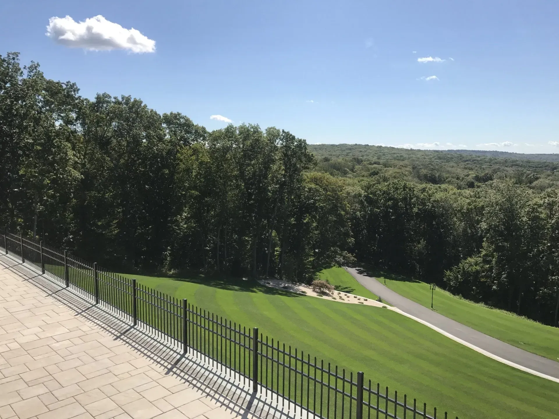 A view of a golf course with trees in the background