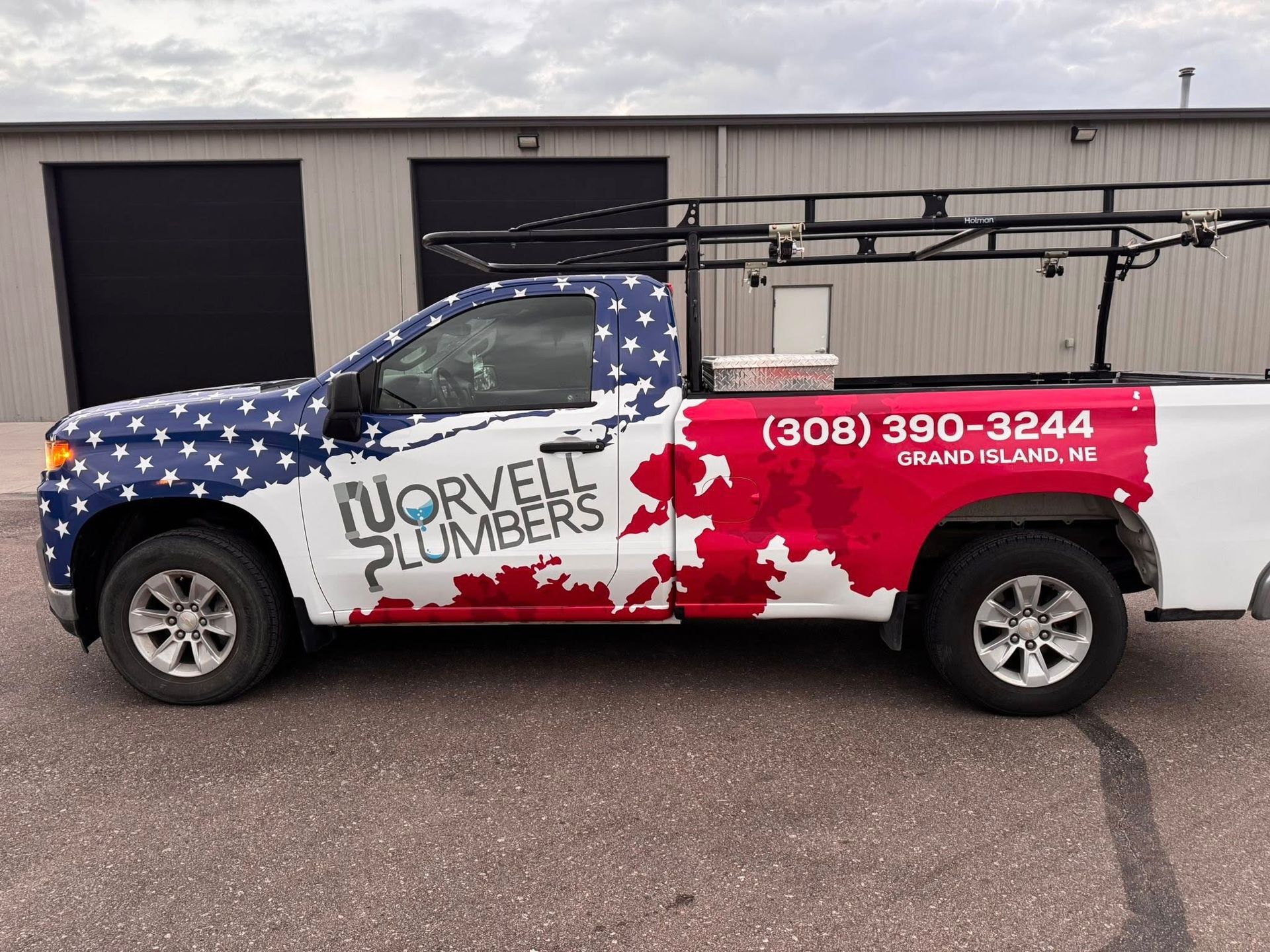 White pickup truck with American flag design, 
