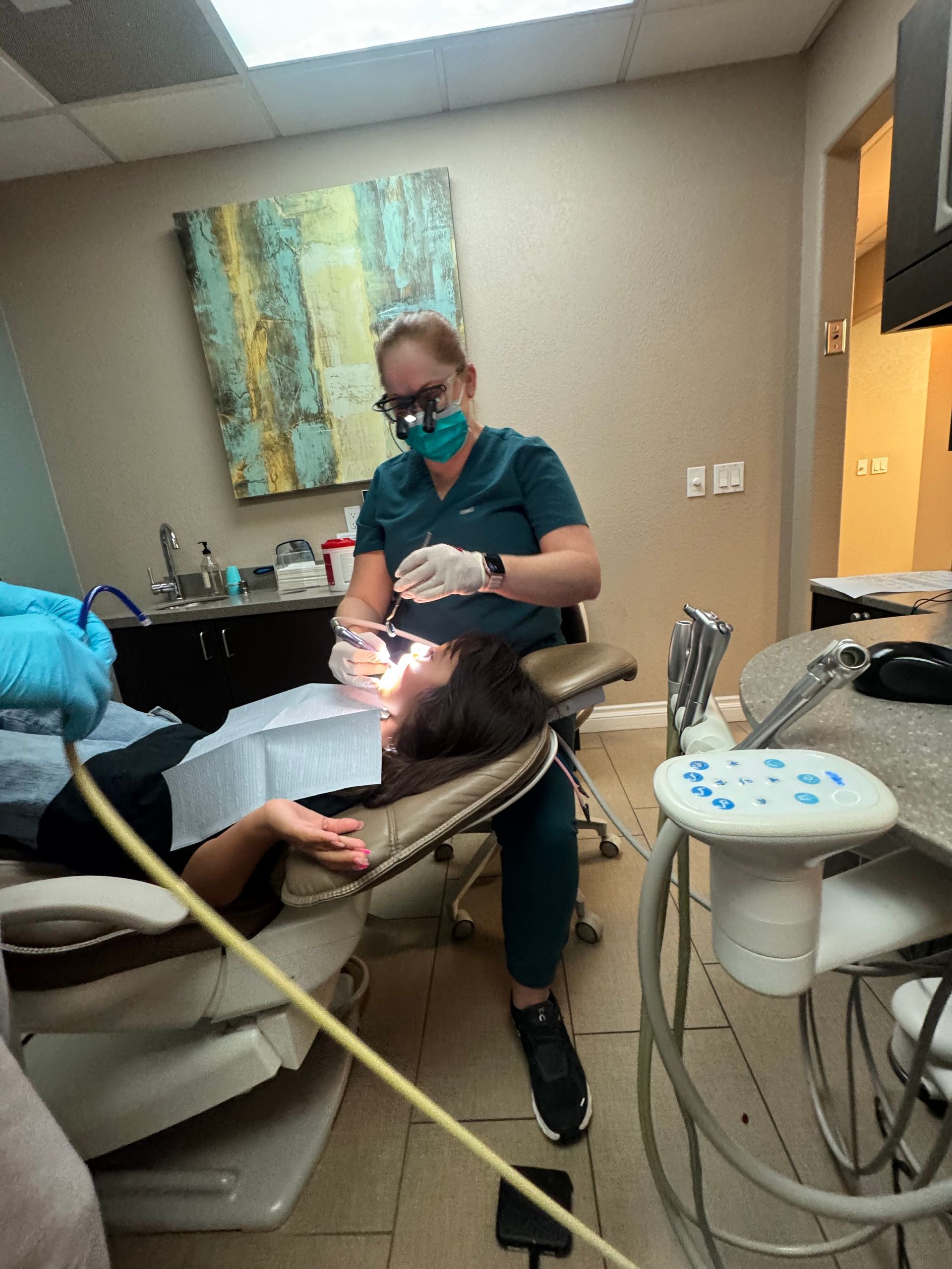A female dentist examines a child patient