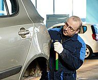 Man repairing a car dent