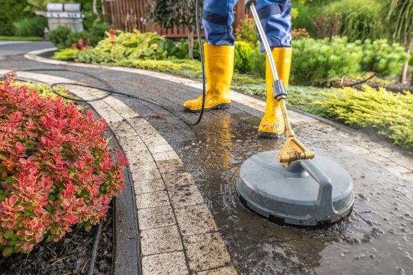 man-doing-pressure-washing-with-a-boots.