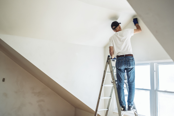 man-in-a-ladder-painting-the-ceiling