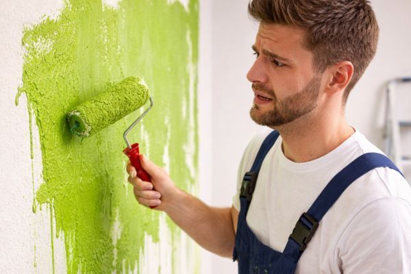man painting the wall incorrectly