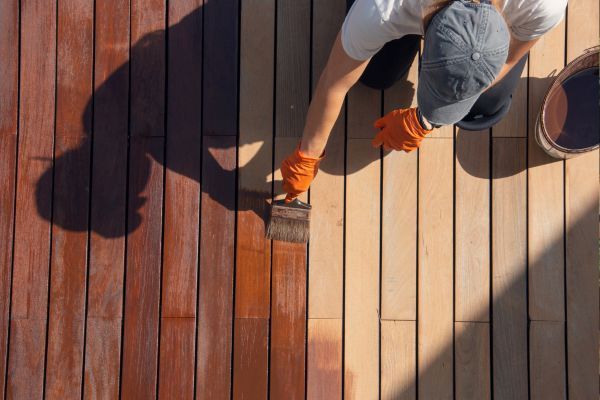 man staining a deck