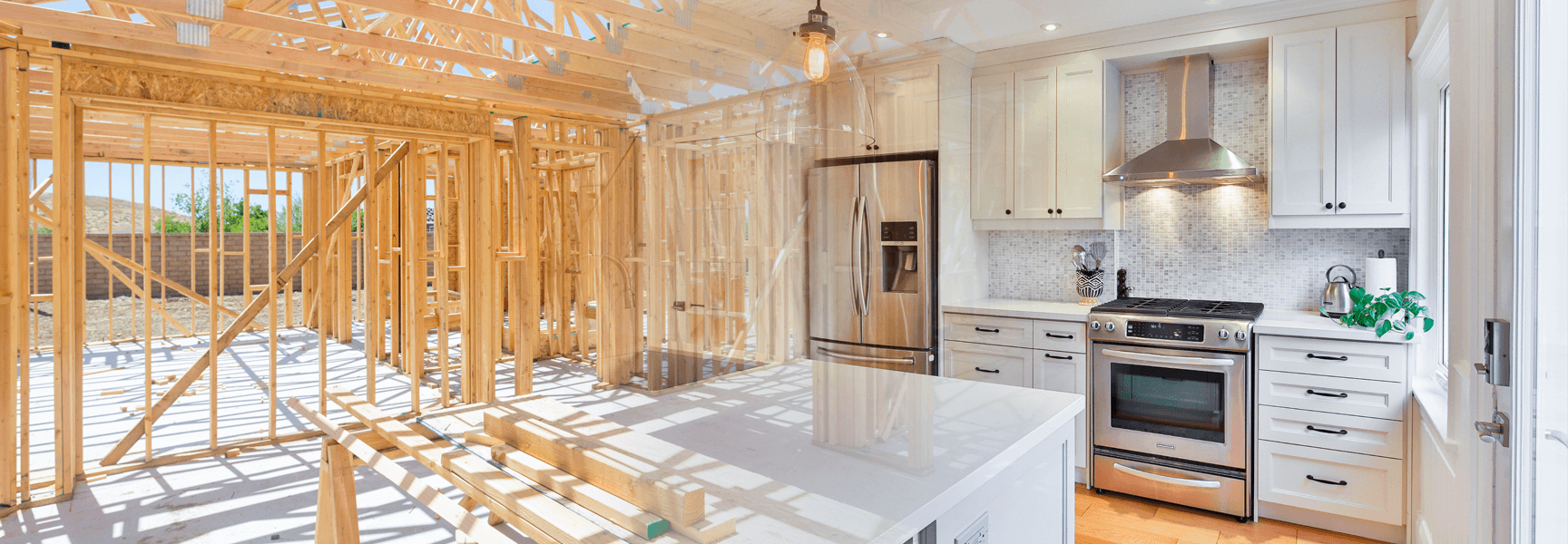 A kitchen under construction, partially framed, with finished cabinets, appliances, and island.