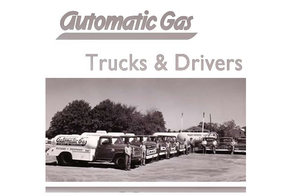Black and white photo: trucks lined up, 