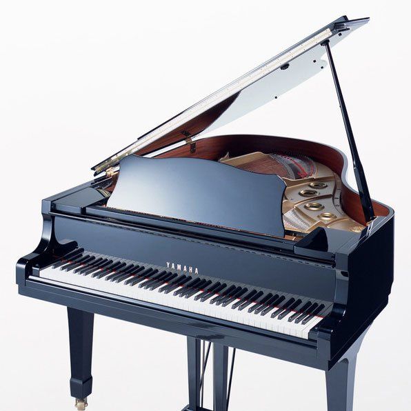 Black Yamaha grand piano with the lid open, keys exposed.
