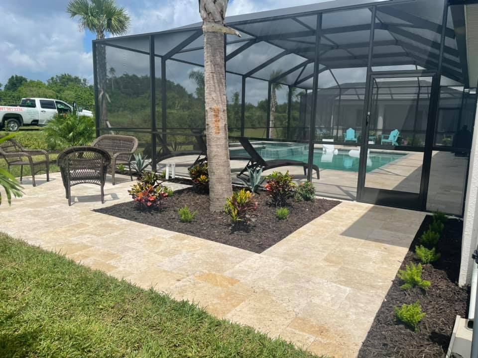 Patio with a screened pool, tiled deck, and landscaping. Dark metal framing surrounds the pool.