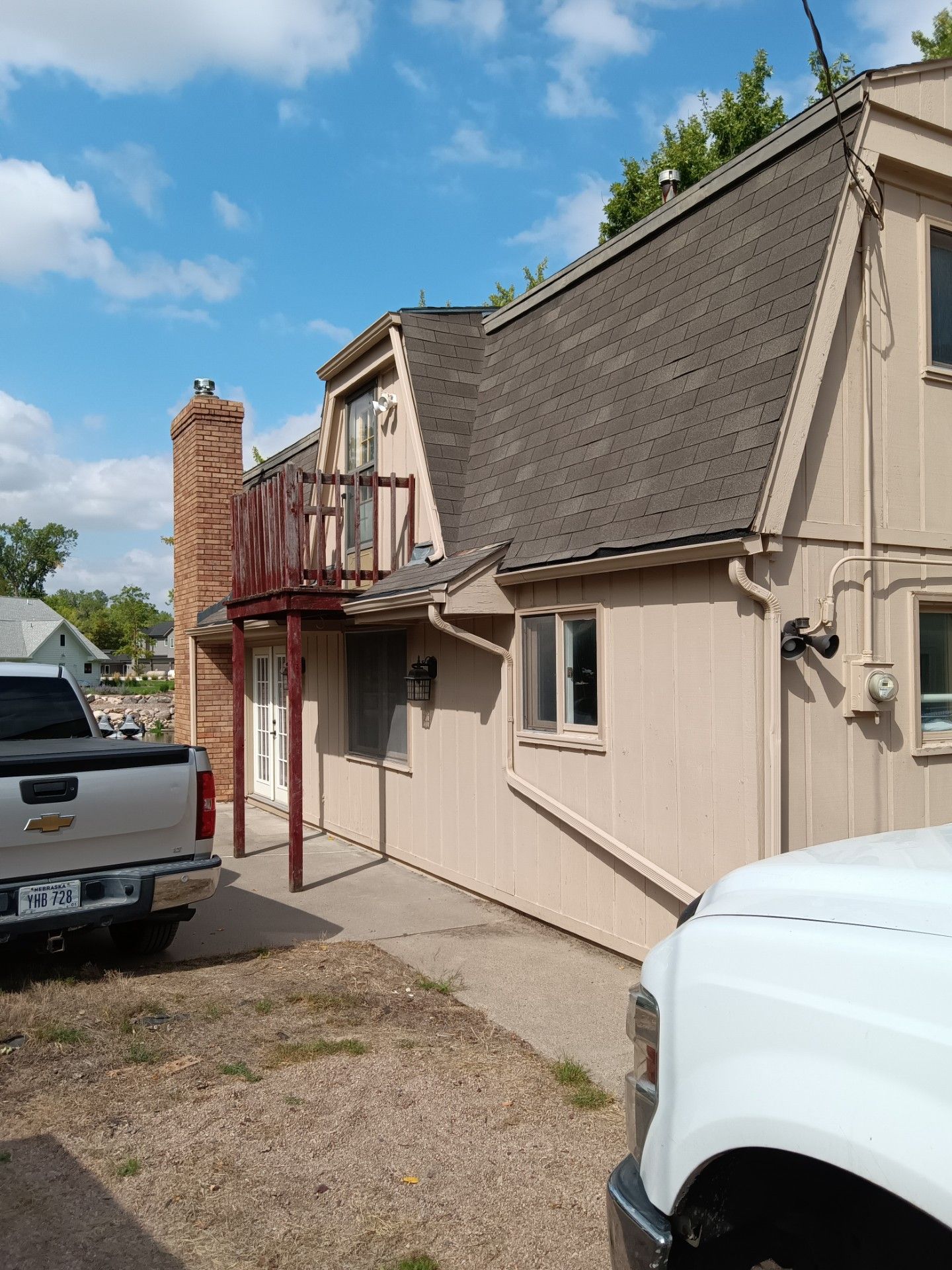 A white truck is parked in front of a house