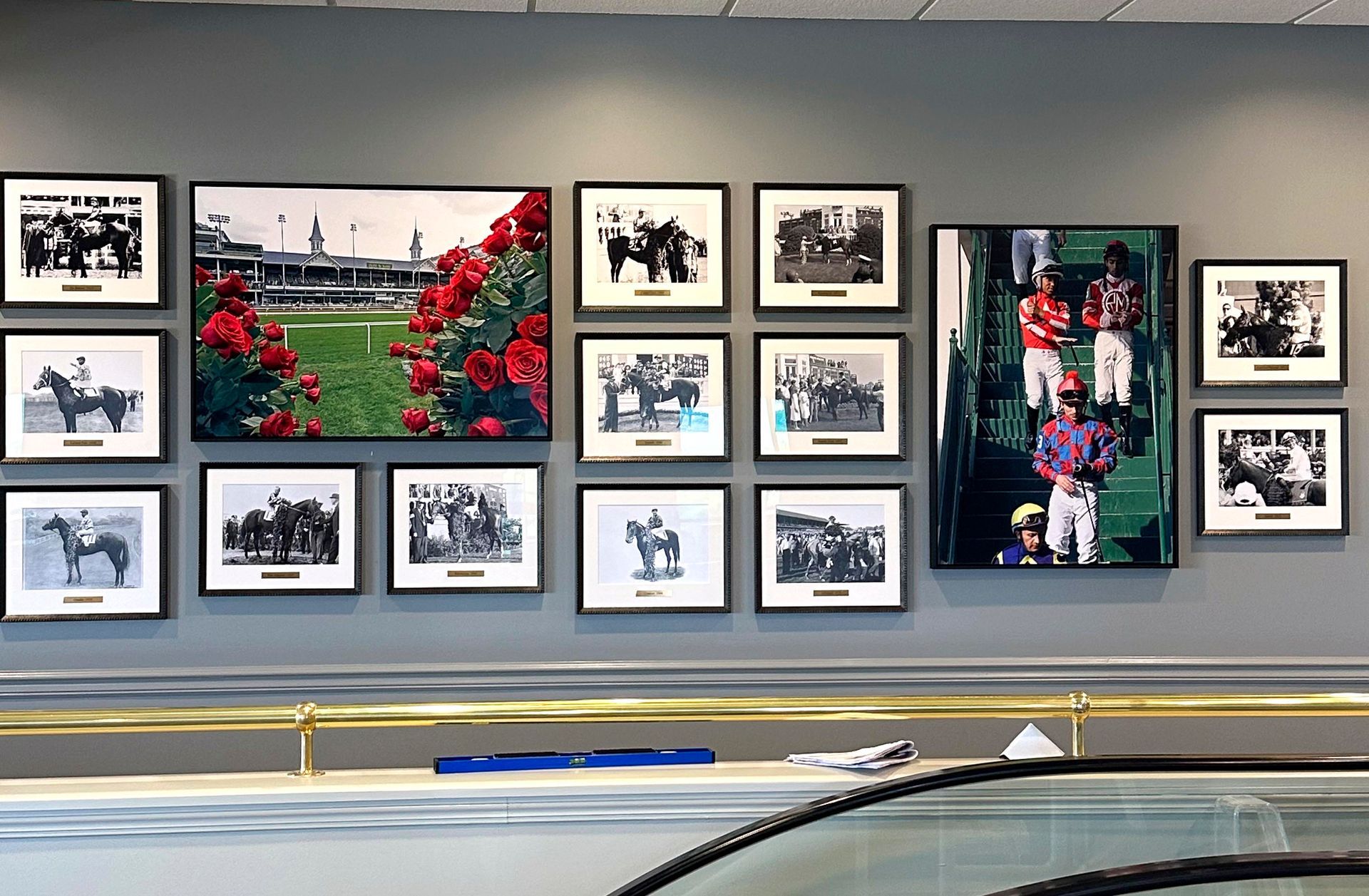 Wall display of framed horse racing photos and memorabilia.