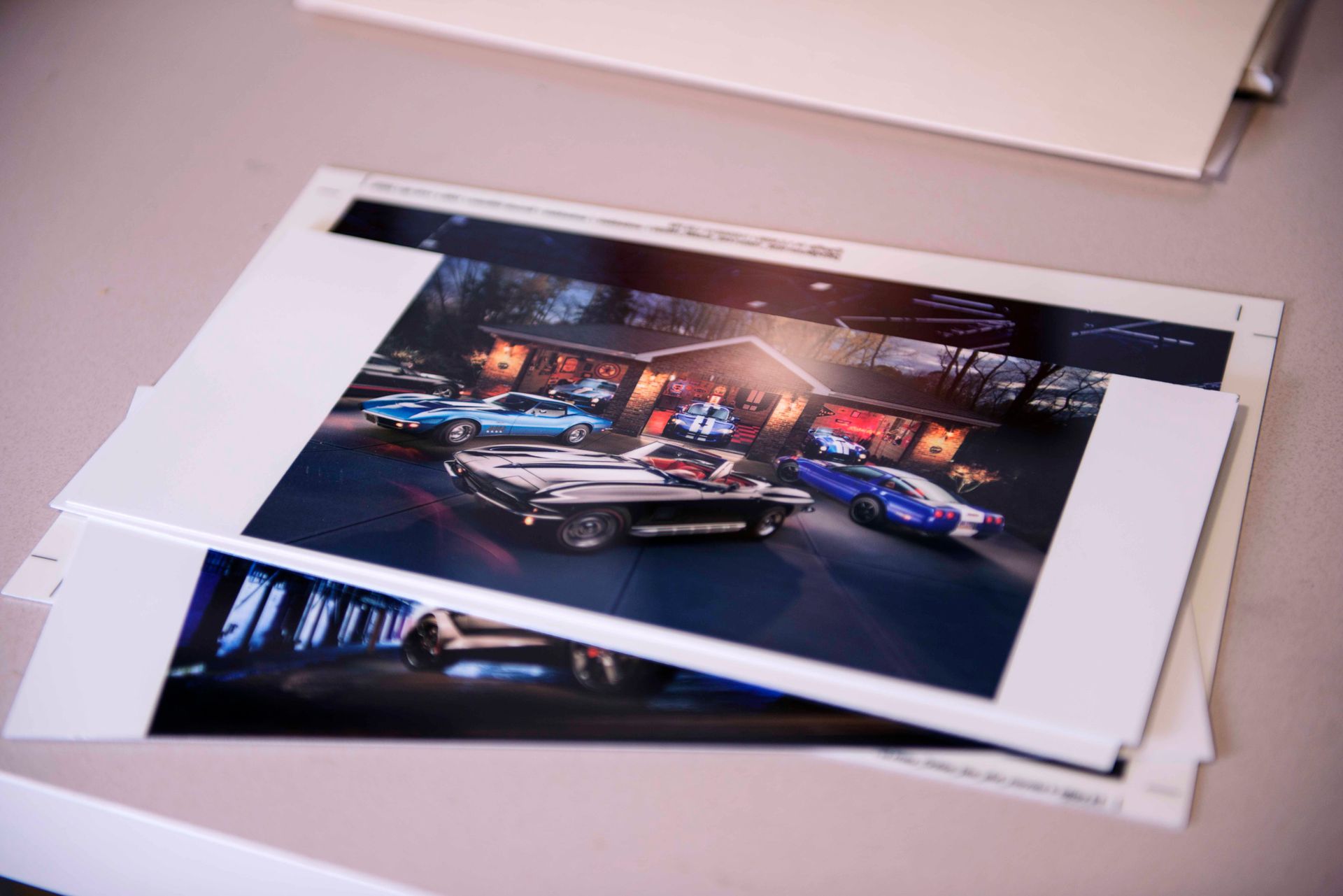 Photos of classic cars parked in front of a building with lit signage.