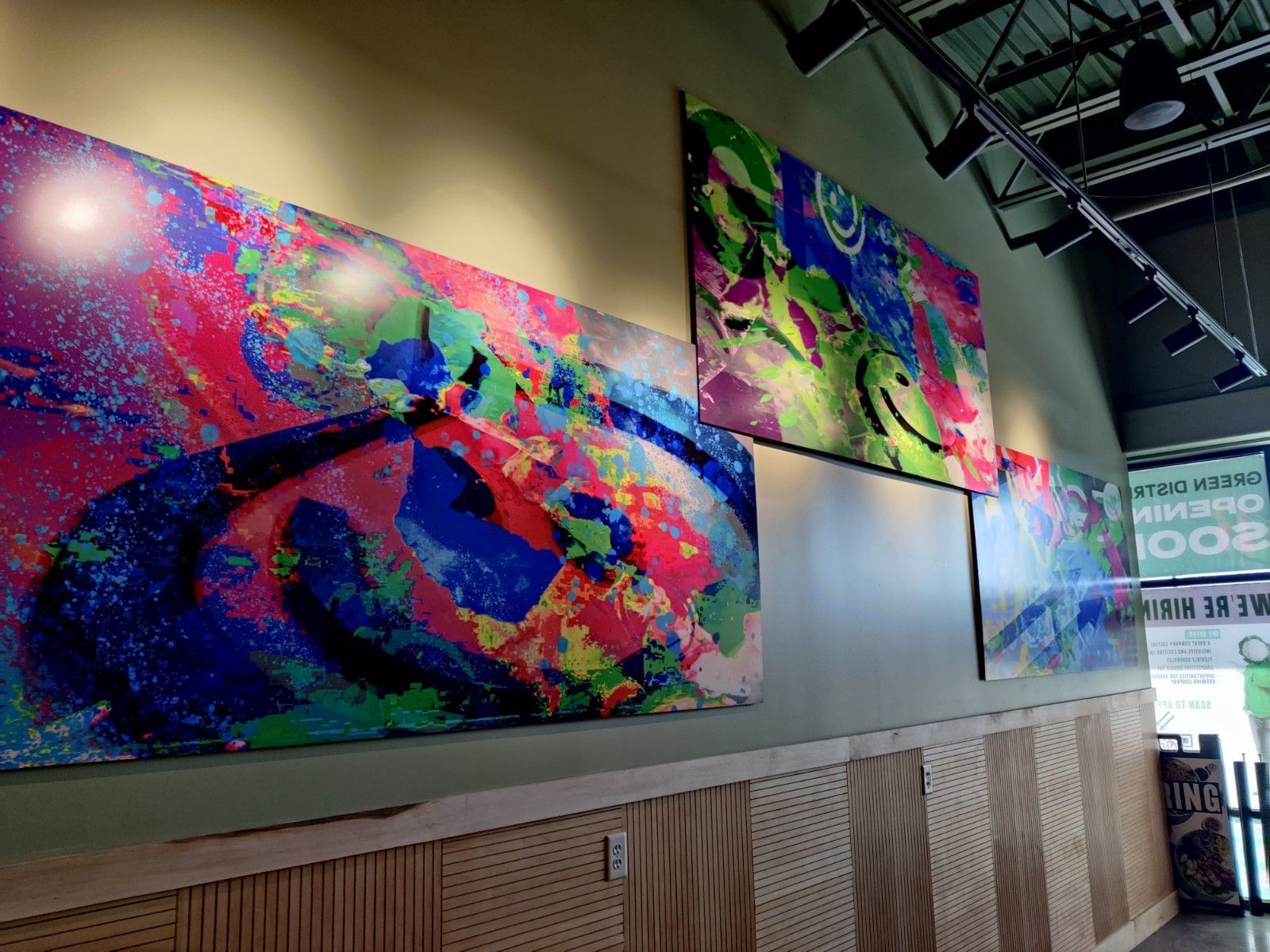 Abstract colorful artwork on a wall inside a building.