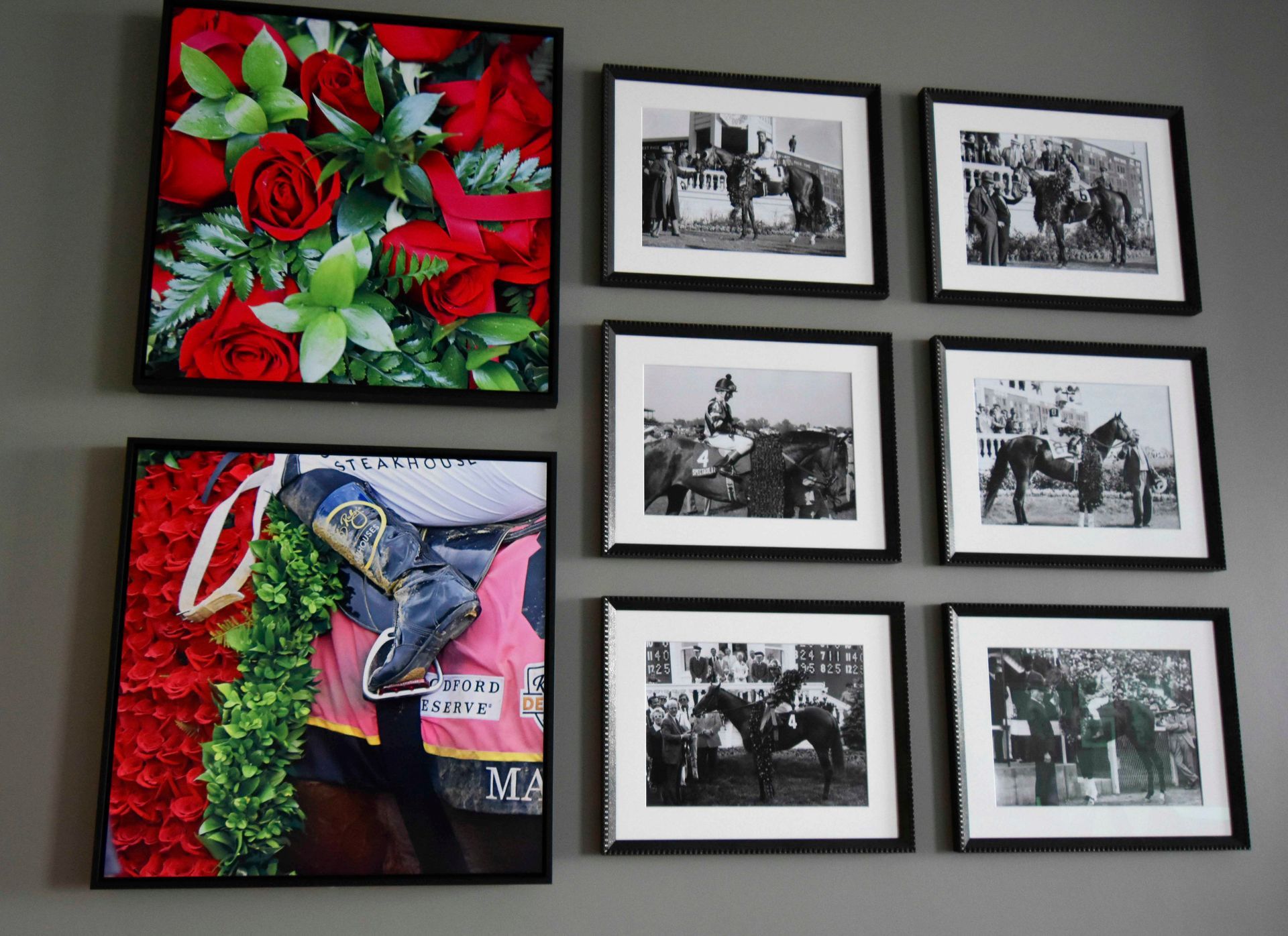Wall art: framed photos and a floral arrangement. Black and white horse racing photos, red roses.