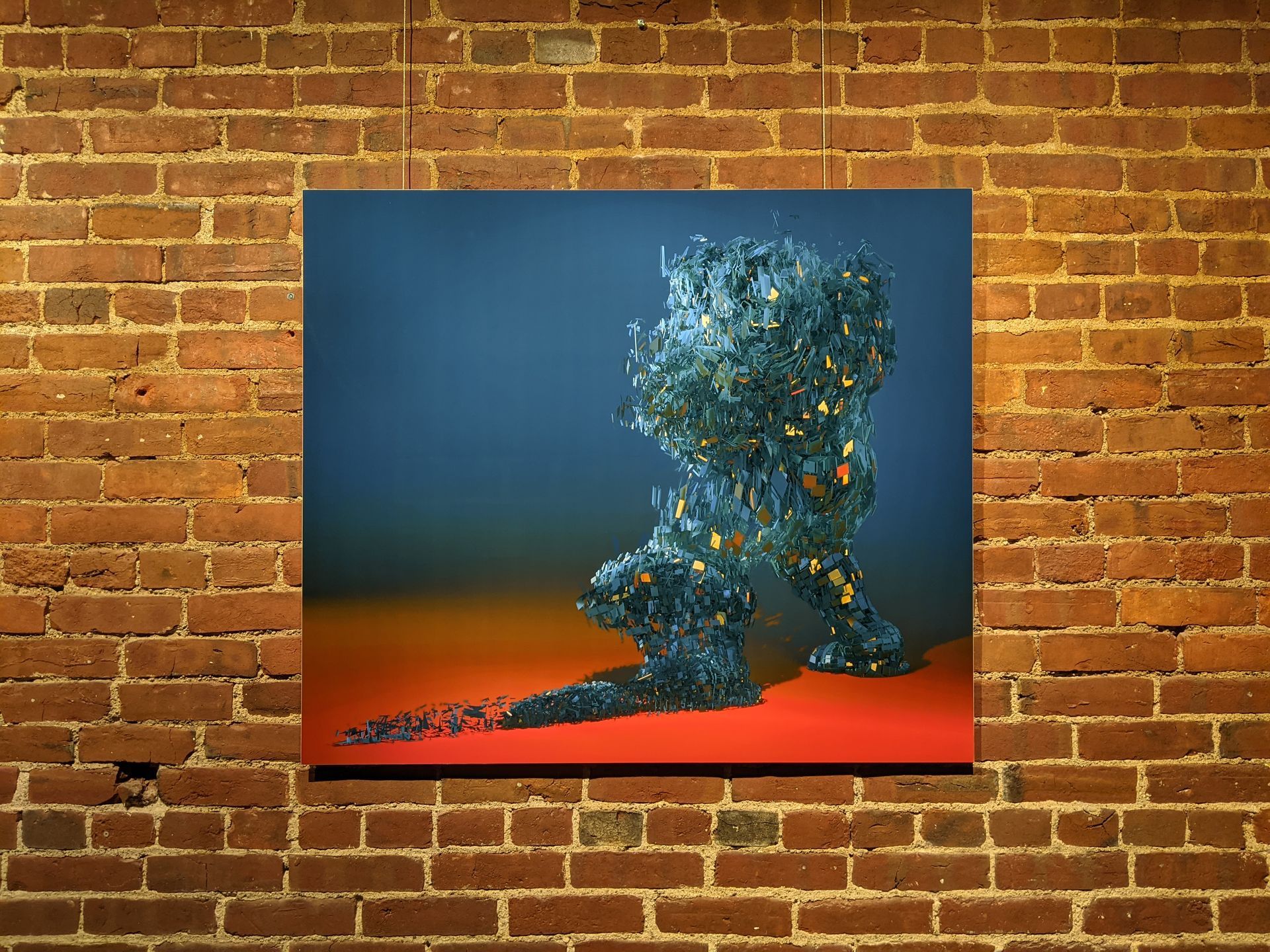 Artwork of a crystalline figure on a red surface against a blue backdrop, mounted on a brick wall.