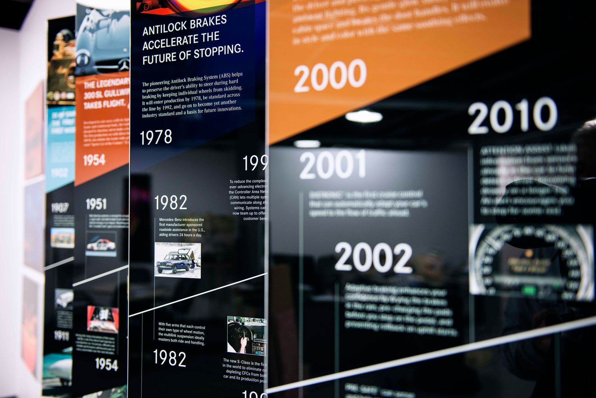 Timeline display with text and images, featuring years and automotive milestones.