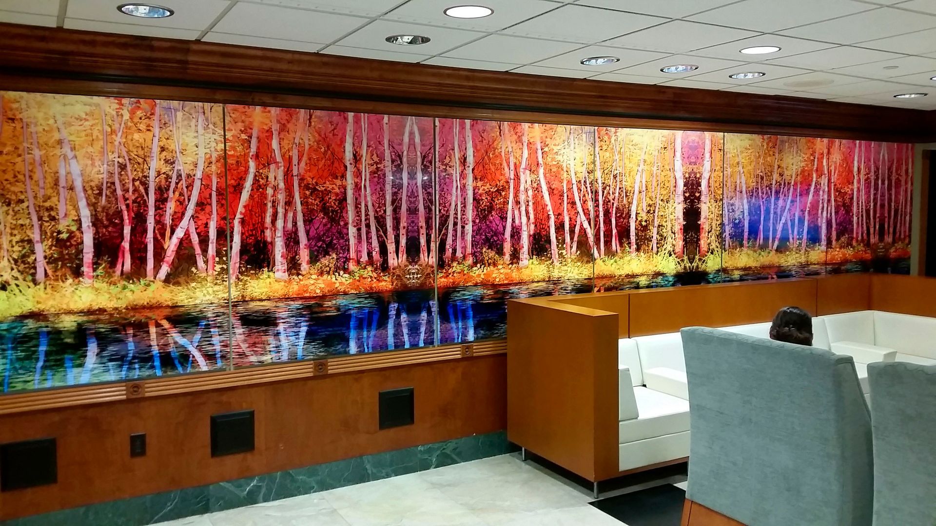 Colorful abstract artwork of autumn trees reflected in water.