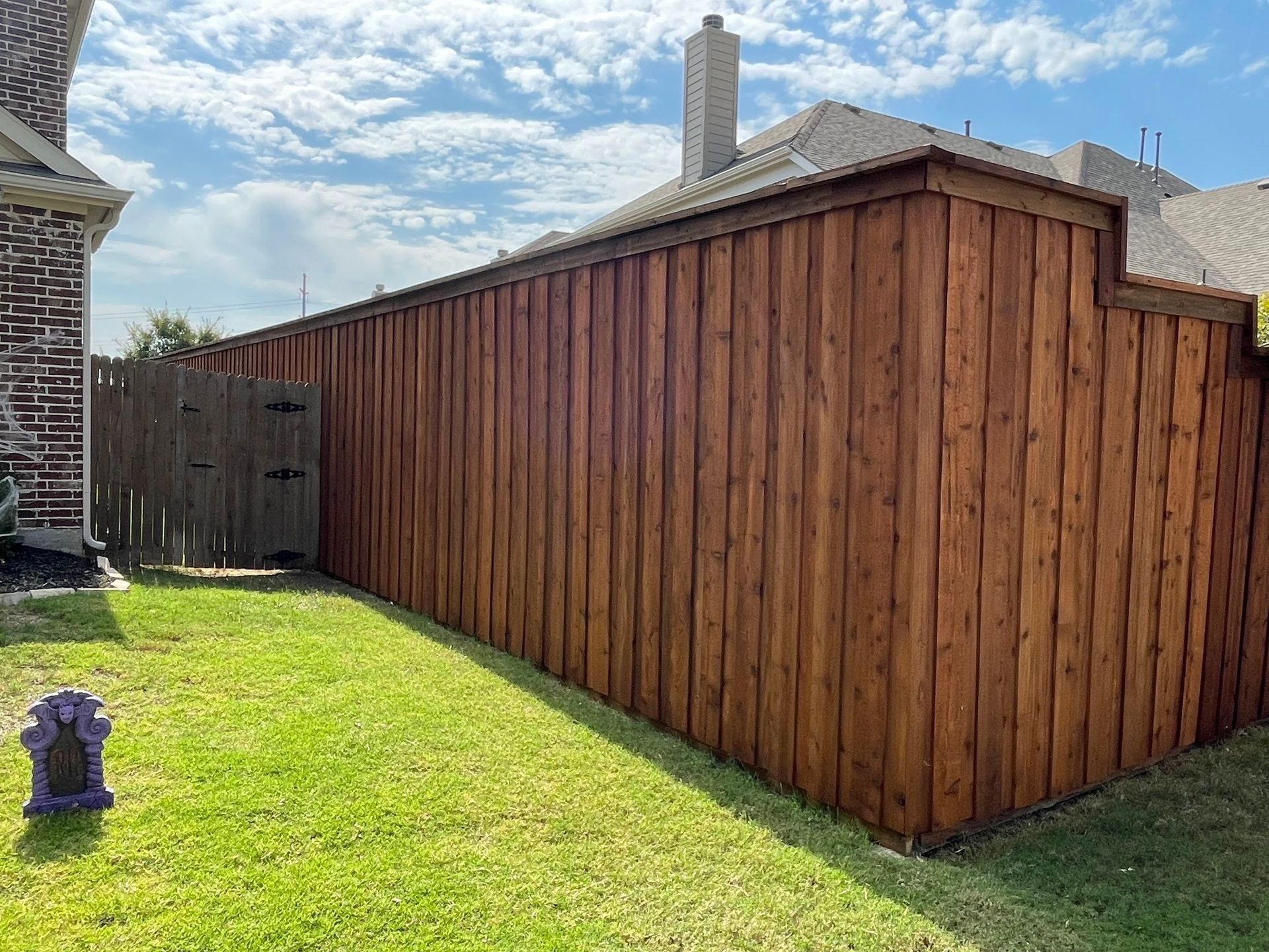 Wooden fence stained brown in the backyard.