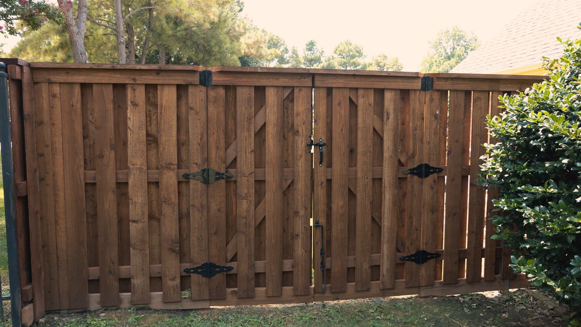 Wooden gate with black hinges