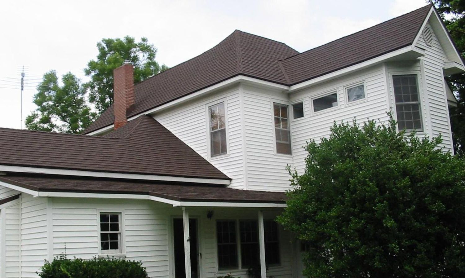 A large white house with a brown roof