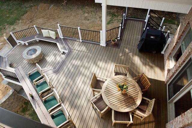An aerial view of a wooden deck with a table and chairs.