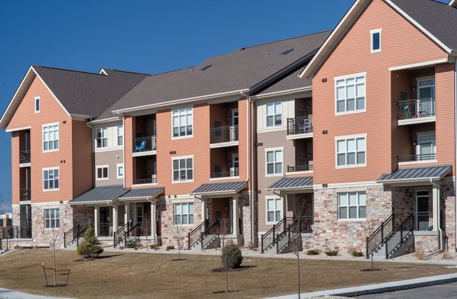 A large apartment building with a lot of windows and balconies