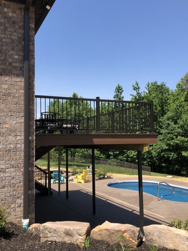 There is a large deck with a swimming pool in the background.