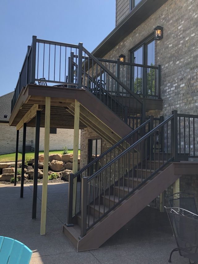 A wooden deck with stairs leading up to it