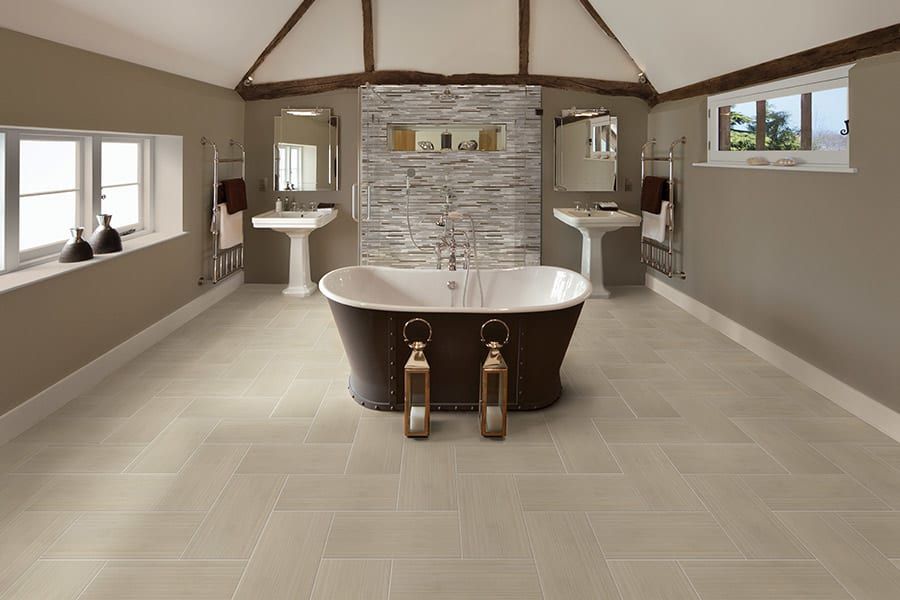 A bathroom with a bathtub and two sinks.